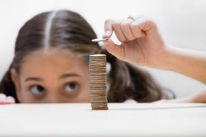 Girl placing a coin on stack